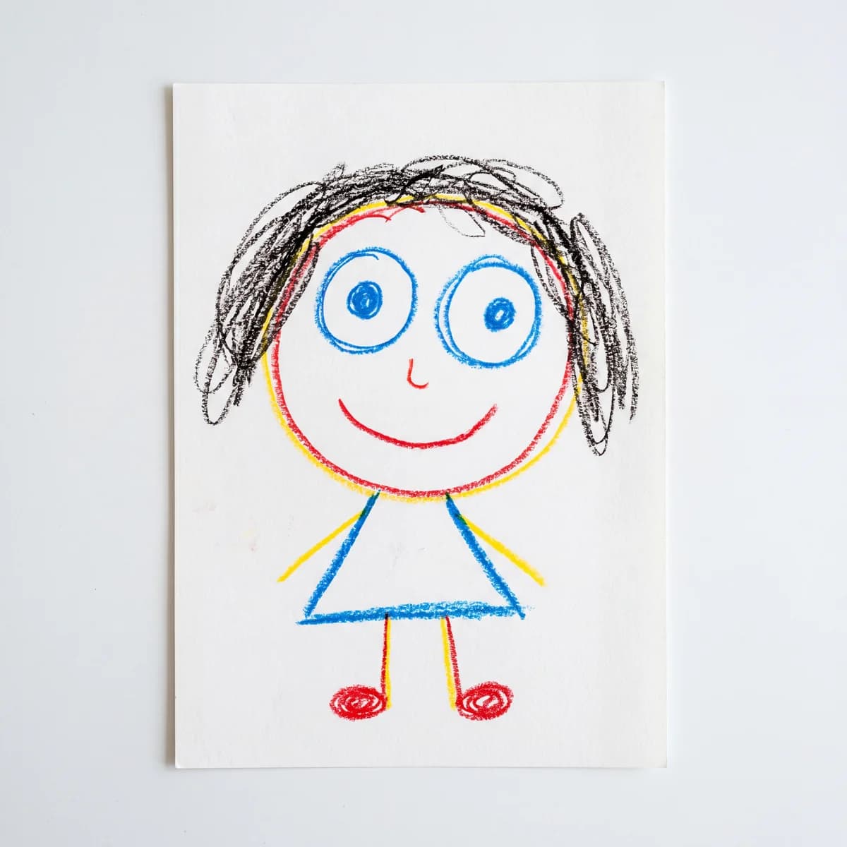 Child's wax crayon self portrait drawing on white paper, the kind PrintCraftMan turns into a UV-printed LED night light keepsake for aunt.